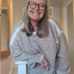 Heather gray knit pullover sweater with round neck and ribbed cuffs, relaxed fit