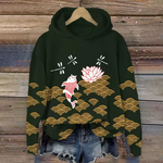 Mabel comfort hoodie, dark green with red figure, pink flowers, and gold wave pattern