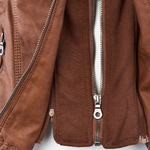 Close-up of brown jacket front zipper placket with metal zippers and snaps