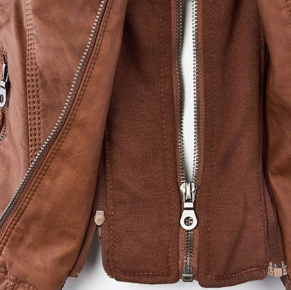 Close-up of brown jacket front zipper placket with metal zippers and snaps