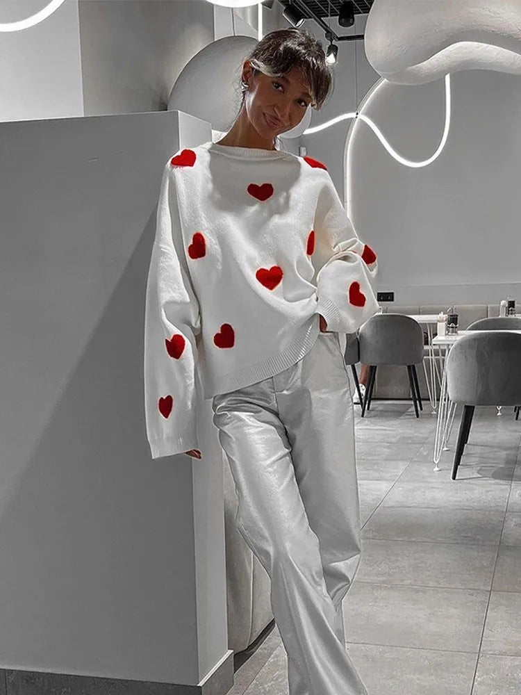 White heart-pattern pullover sweater with relaxed wide sleeves and ribbed hem.