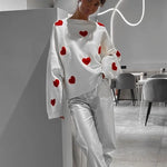 White heart-pattern pullover sweater with relaxed wide sleeves and ribbed hem.