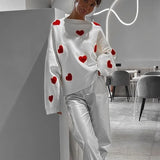 White heart-pattern pullover sweater with relaxed wide sleeves and ribbed hem.