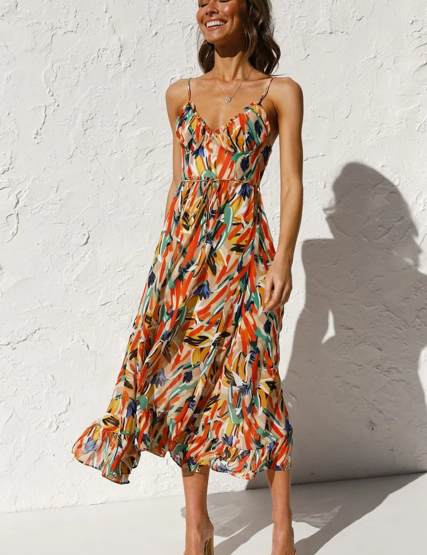 Elegant midi dress with spaghetti straps and multicolor abstract print, ruffled hem