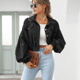 Black cropped jacket with flap pockets, button front, and long puff sleeves