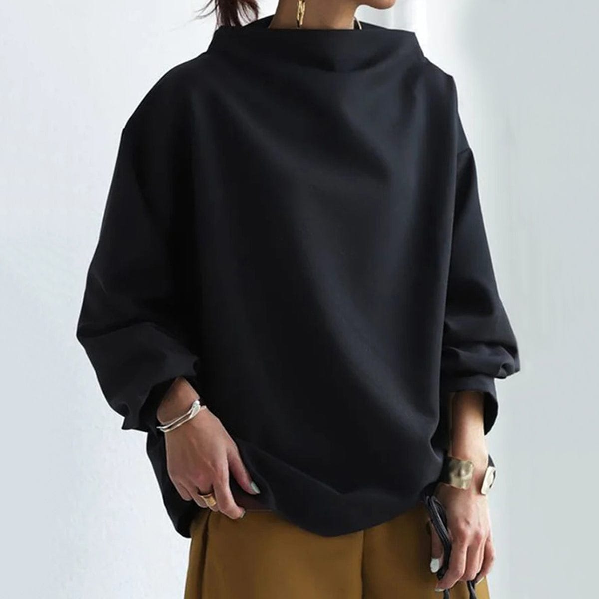 Black high-neck soft knit top with balloon sleeves and loose drape