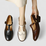 Set of Mary Jane shoes: black, white, and brown with buckle straps and low heels