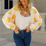 White cropped V-neck cardigan with long sleeves and yellow floral print