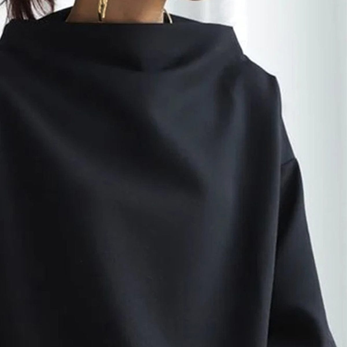 Black high-neck soft knit top neckline view with wide collar