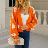 Orange cropped V-neck cardigan with long sleeves and white flower print
