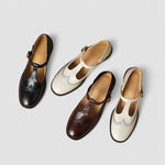 Mary Jane shoes in black, brown, and white/beige with buckle straps