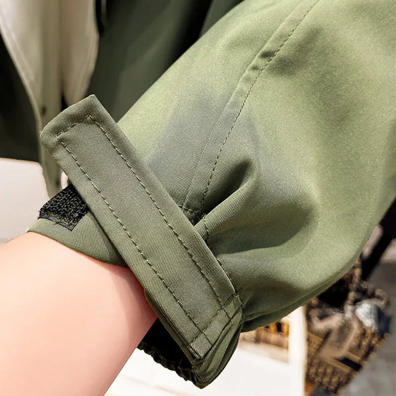 Olive green windbreaker jacket sleeve cuff with stitched tab