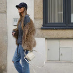 Cropped brown faux-fur jacket on model, long sleeves and shaggy texture