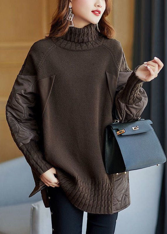 Dark brown knit turtleneck sweater with textured patchwork sleeves and side panels