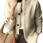 Off-white button-front knit cardigan with dark buttons and ribbed cuffs