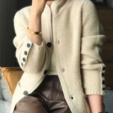 Off-white cozy knit cardigan with button placket and dark cuff buttons