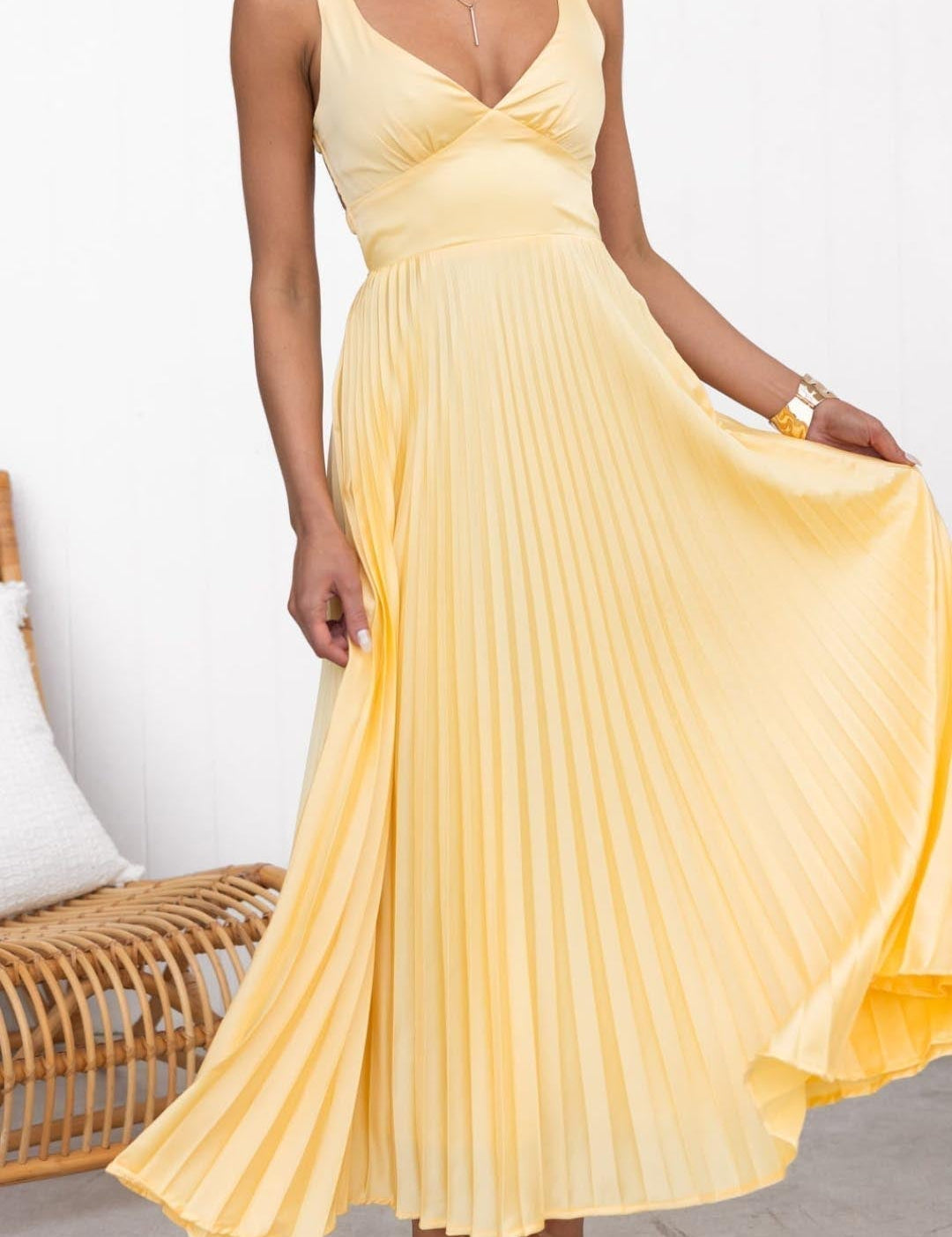 Yellow pleated V-neck maxi dress with spaghetti straps and fitted bodice