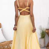Yellow pleated maxi dress, crisscross back straps and open-back neckline shape