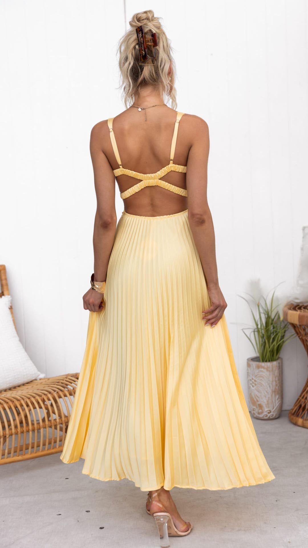 Yellow pleated maxi dress, crisscross back straps and open-back neckline shape