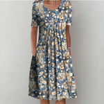 Blue and beige floral midi dress with scoop neckline and short sleeves, gathered skirt