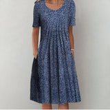 Navy polka-dot midi dress with scoop neckline and short sleeves, gathered skirt