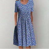 Blue patterned midi dress with scoop neckline and short sleeves, gathered skirt
