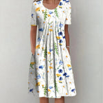 White floral midi dress with scoop neckline and short sleeves, gathered skirt