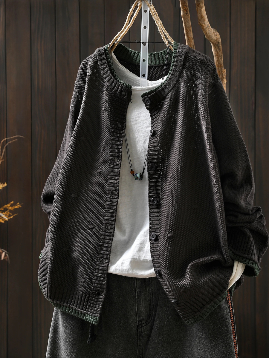Black structured cardigan with button front and ribbed cuffs, textured knit fabric