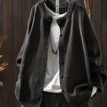 Black structured cardigan with button front and ribbed cuffs, textured knit fabric