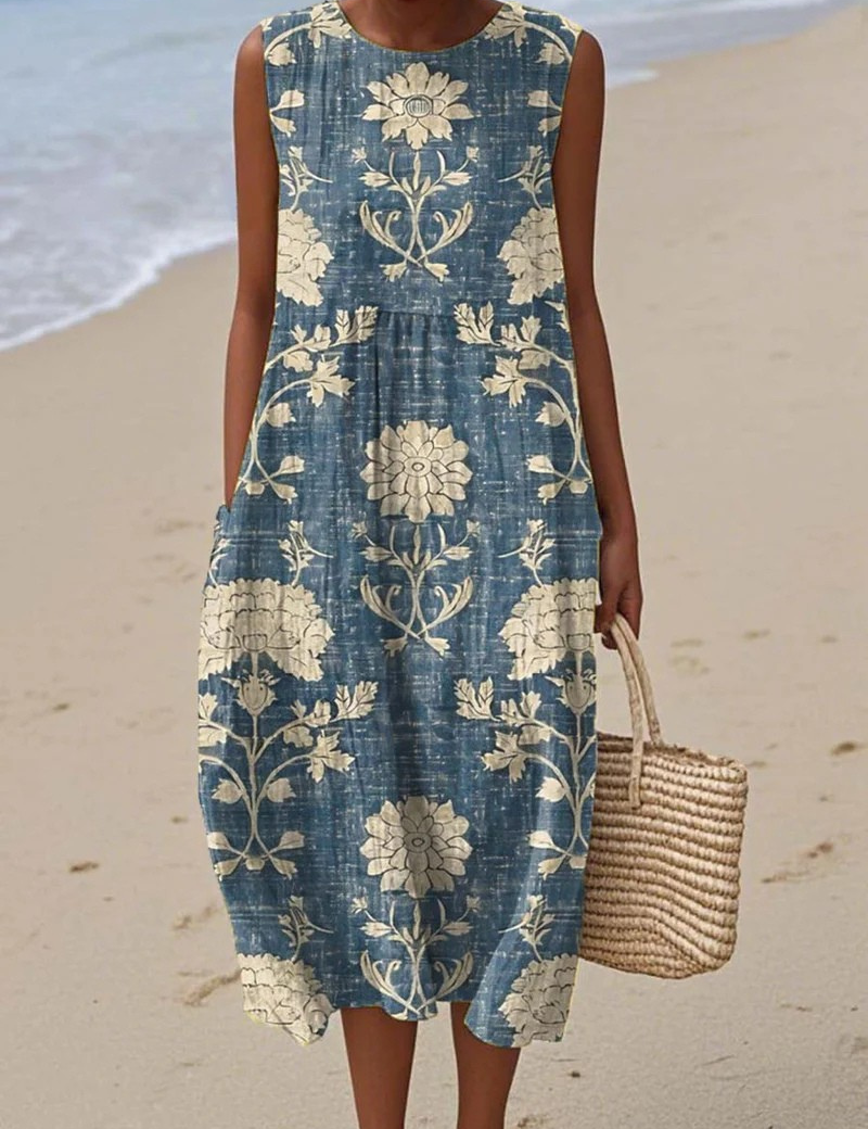 Sleeveless blue beach dress with cream floral print and gathered waist