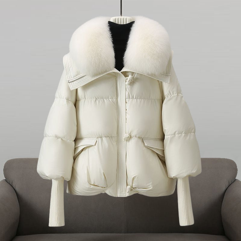 White puffer jacket with white faux fur collar, front zip and flap pockets