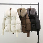 Hanging winter puffer jackets: white, brown, and black with faux fur collars