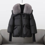 Black puffer jacket with gray faux fur collar, button-front zip and flap pockets