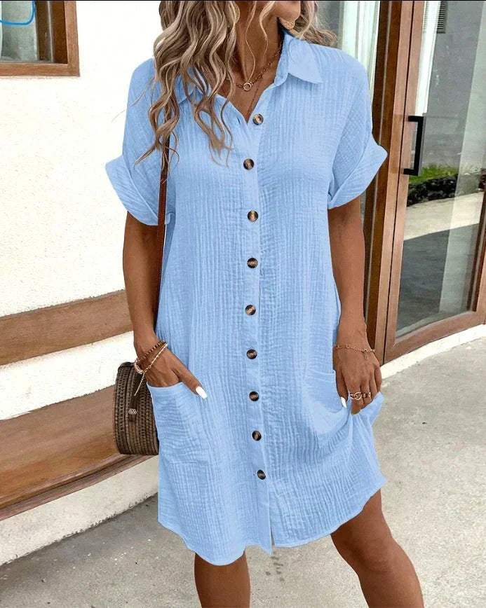 Light blue polo shirt dress with short sleeves, button placket, and side pockets