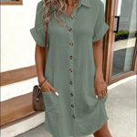 Green polo shirt dress with short sleeves, button placket, and side pockets