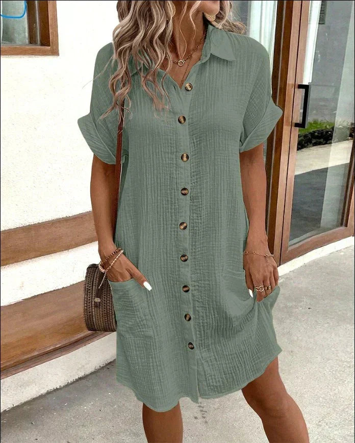 Green polo shirt dress with short sleeves, button placket, and side pockets