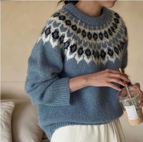Blue jacquard knit pullover sweater with fair isle pattern and ribbed crew neck.