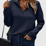Dark navy ribbed half-zip knit sweater with long sleeves.