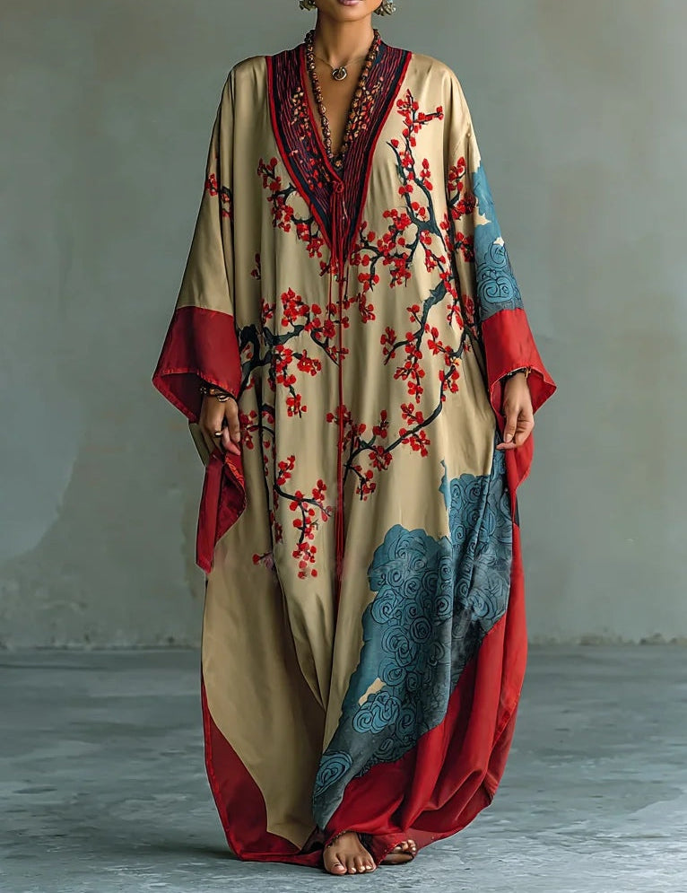 Cream maxi dress with batwing sleeves, V-neck, red plum blossom print and blue accents.