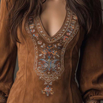 Brown suede minidress front with ornate V-stitch embroidery and long sleeves