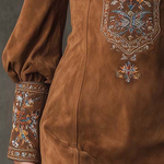 Brown suede mini dress with embroidered cuffs and V-neck trim