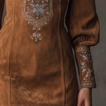 Brown suede minidress with central floral embroidery and long cuffed sleeves