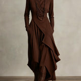 Brown long-sleeve maxi dress with high neck and layered draped wrap skirt
