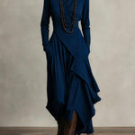 Navy long-sleeve maxi dress with high collar and layered wrap drape