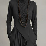 Black long-sleeve maxi dress with high neck, wrapped front and draped overlay