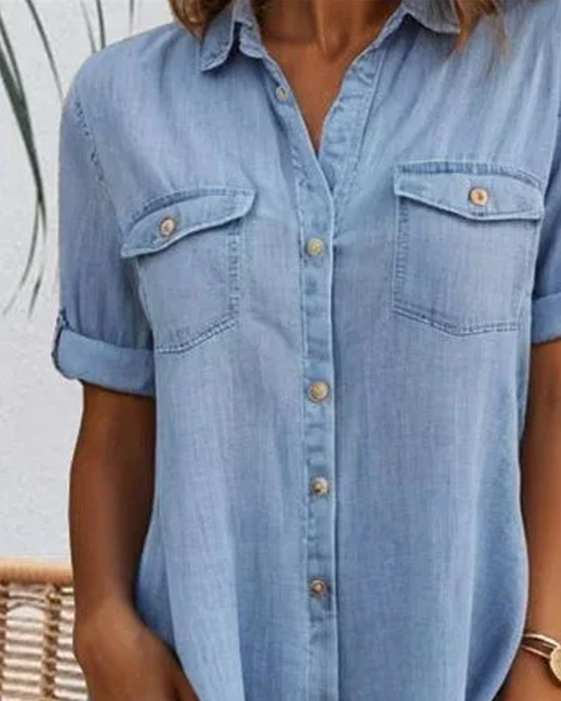 Light blue denim shirt dress front detail with button placket and chest pockets