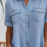 Light blue denim shirt dress front detail with button placket and chest pockets