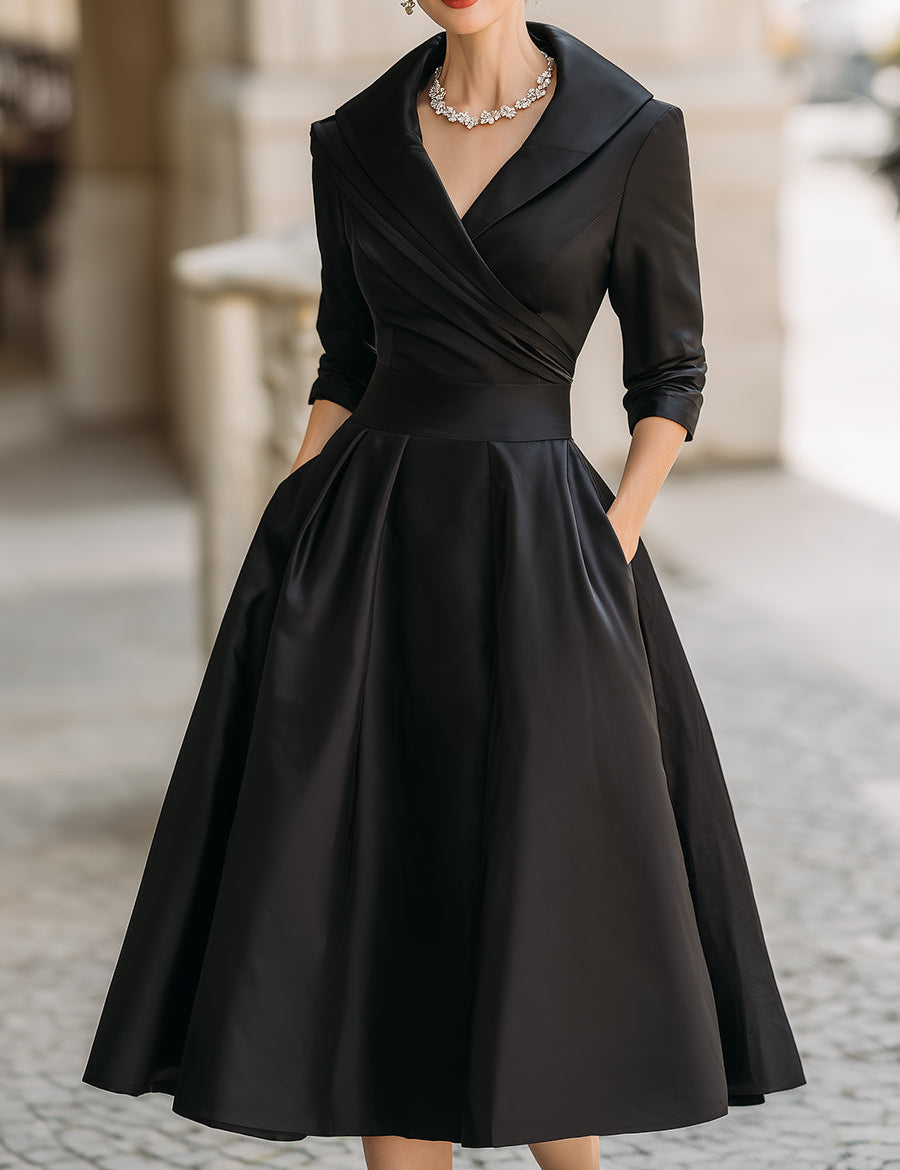 Black satin wrap-style evening dress with V-neck, 3/4 sleeves, and flared skirt