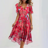 Knee-length red floral wrap dress with short sleeves, V-neck, and cinched waist