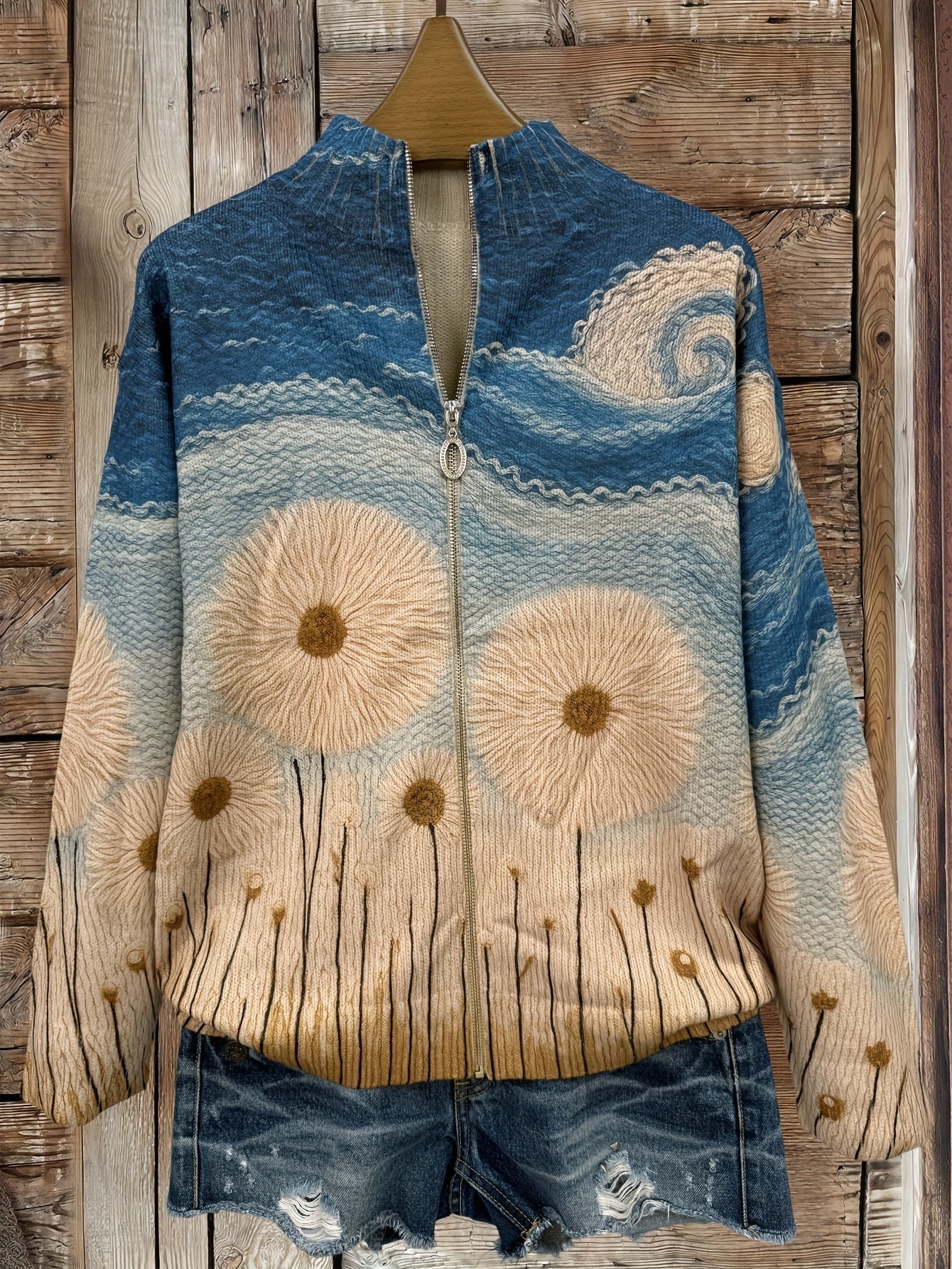 Women's quilted knit zipper jacket in blue and cream with daisy embroidery, front view